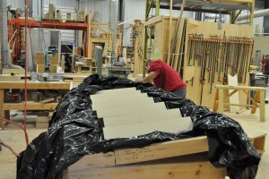 Photo of employees preparing stairs for transport.